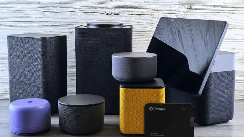 Enceintes connectées, boîtiers et tablette posés sur une table en bois